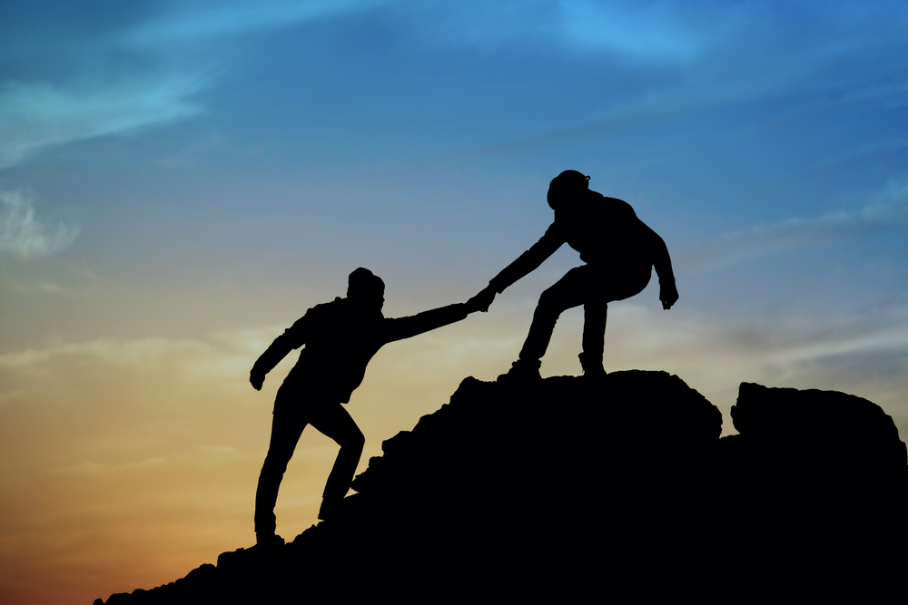 mountain climbers helping hand